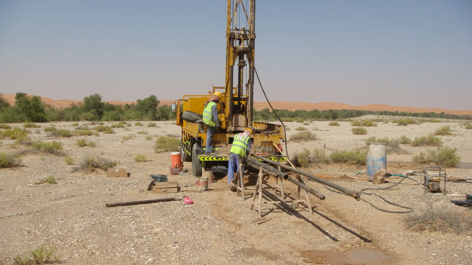 A geotechnical drilling rig working on open desert ground