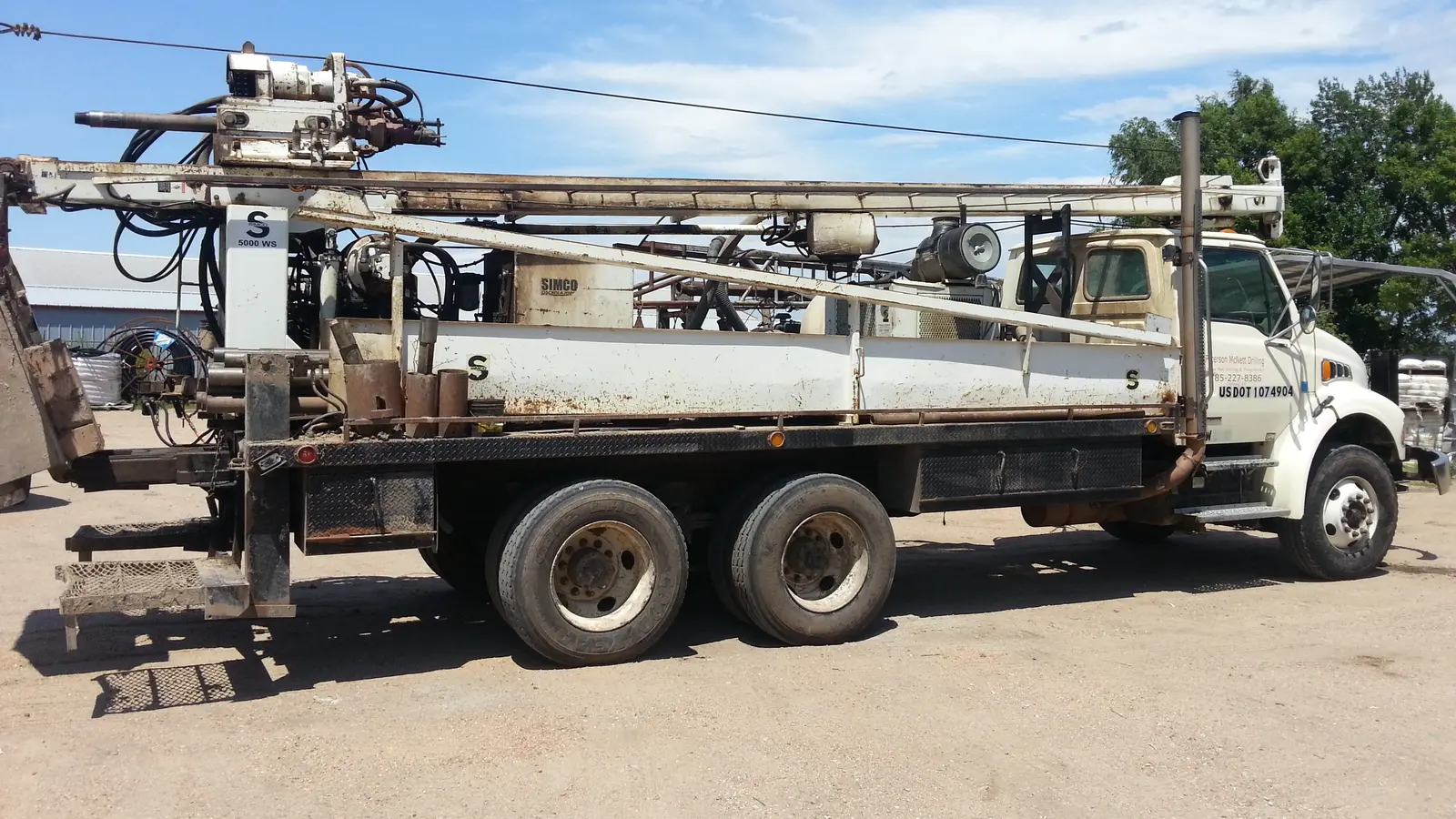 A truck-mounted water well drilling rig