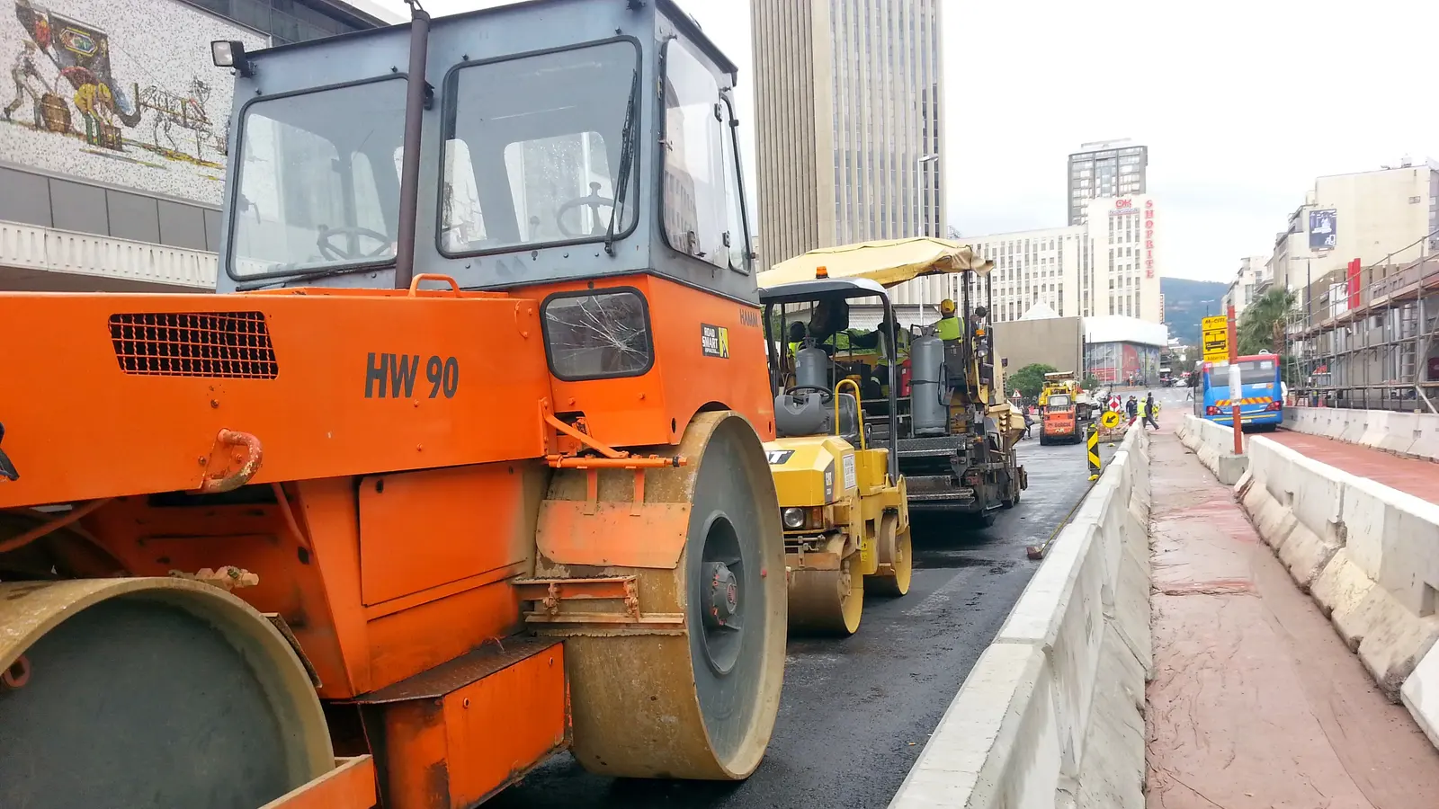 A roller compacting fresh asphalt on a city road