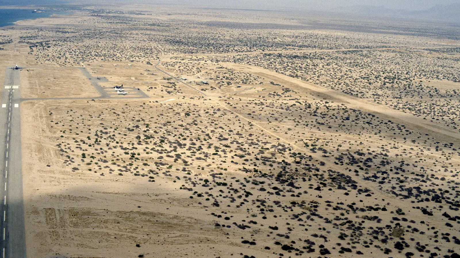 Berbera airport's runway and apron from the air, with the coast beyond