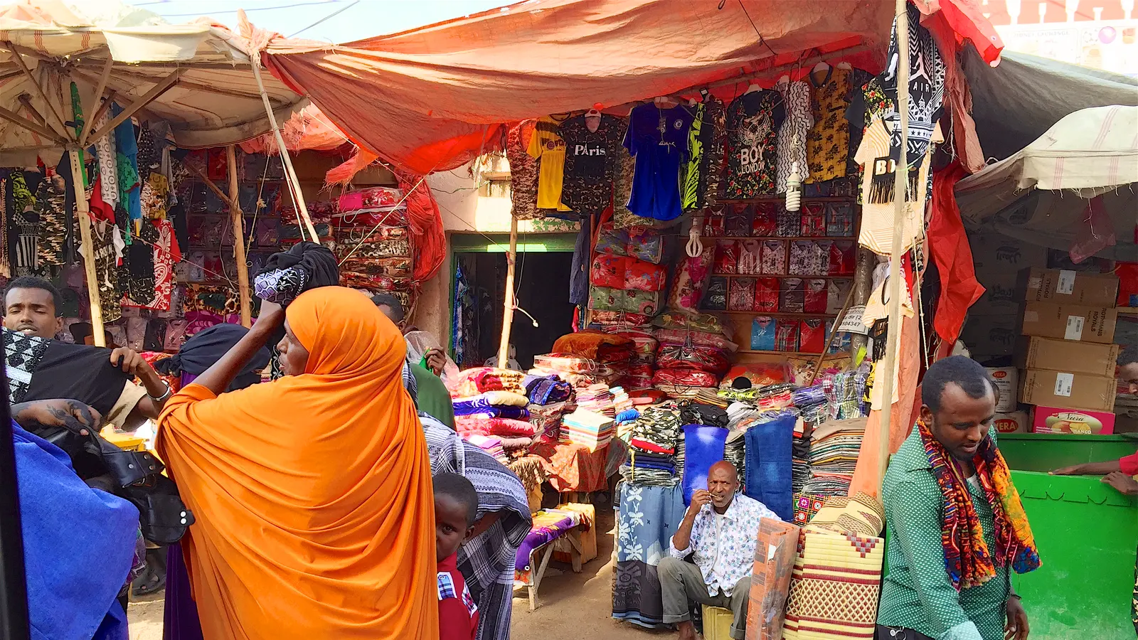 Traders and shoppers at a covered street market in Hargeisa