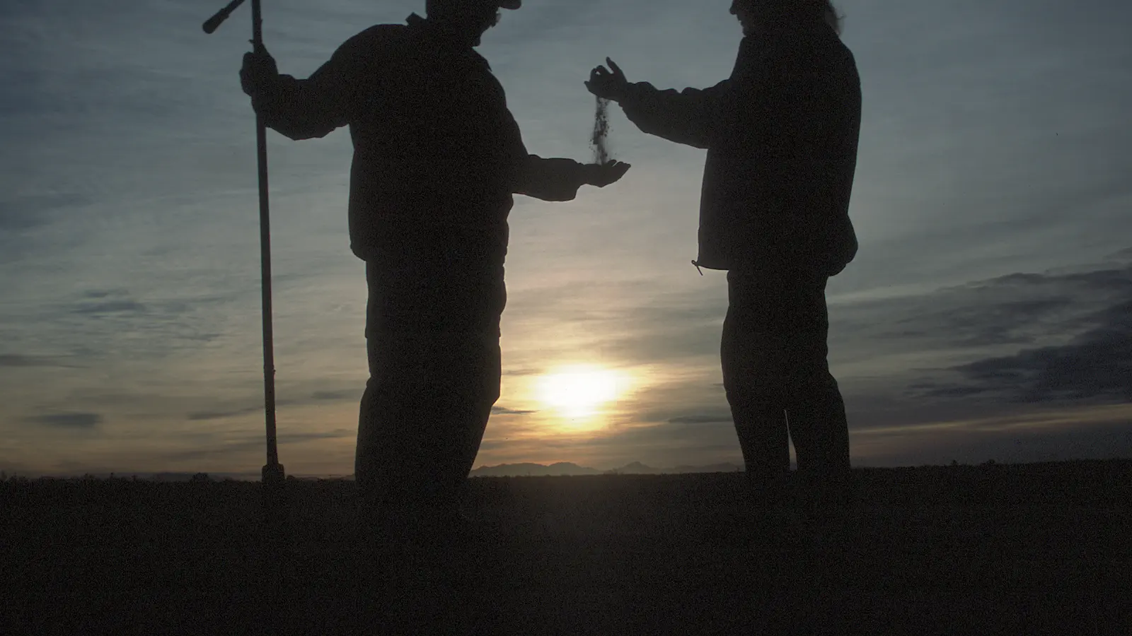 Technicians collecting soil samples in a field