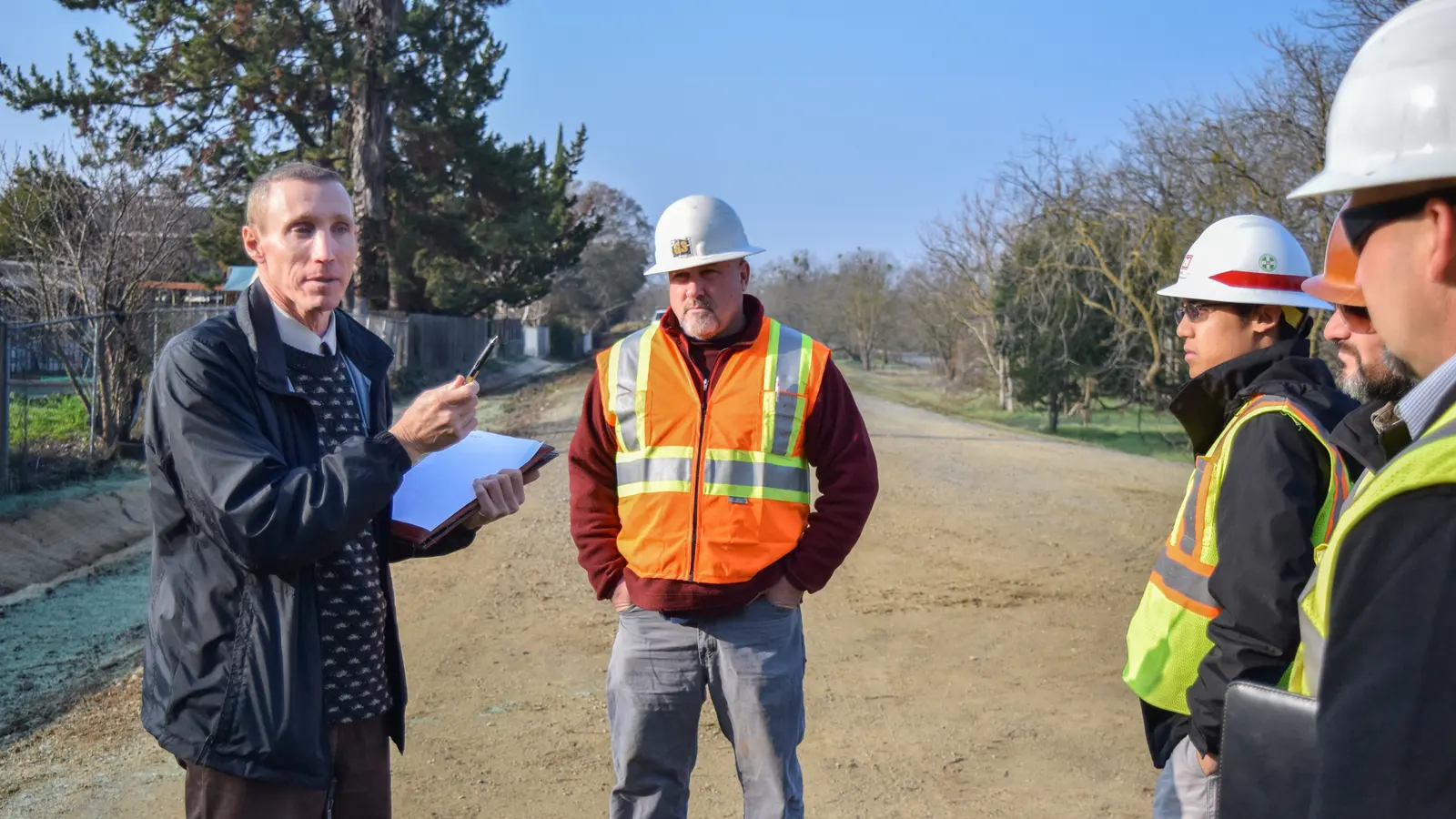 Engineers in hard hats discussing a site inspection